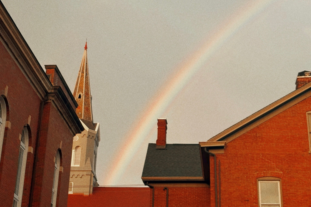 A rainbow falls on a church